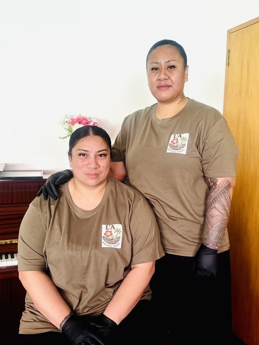 The two owners of L'A Pacific Taste & Caterers in branded shirts